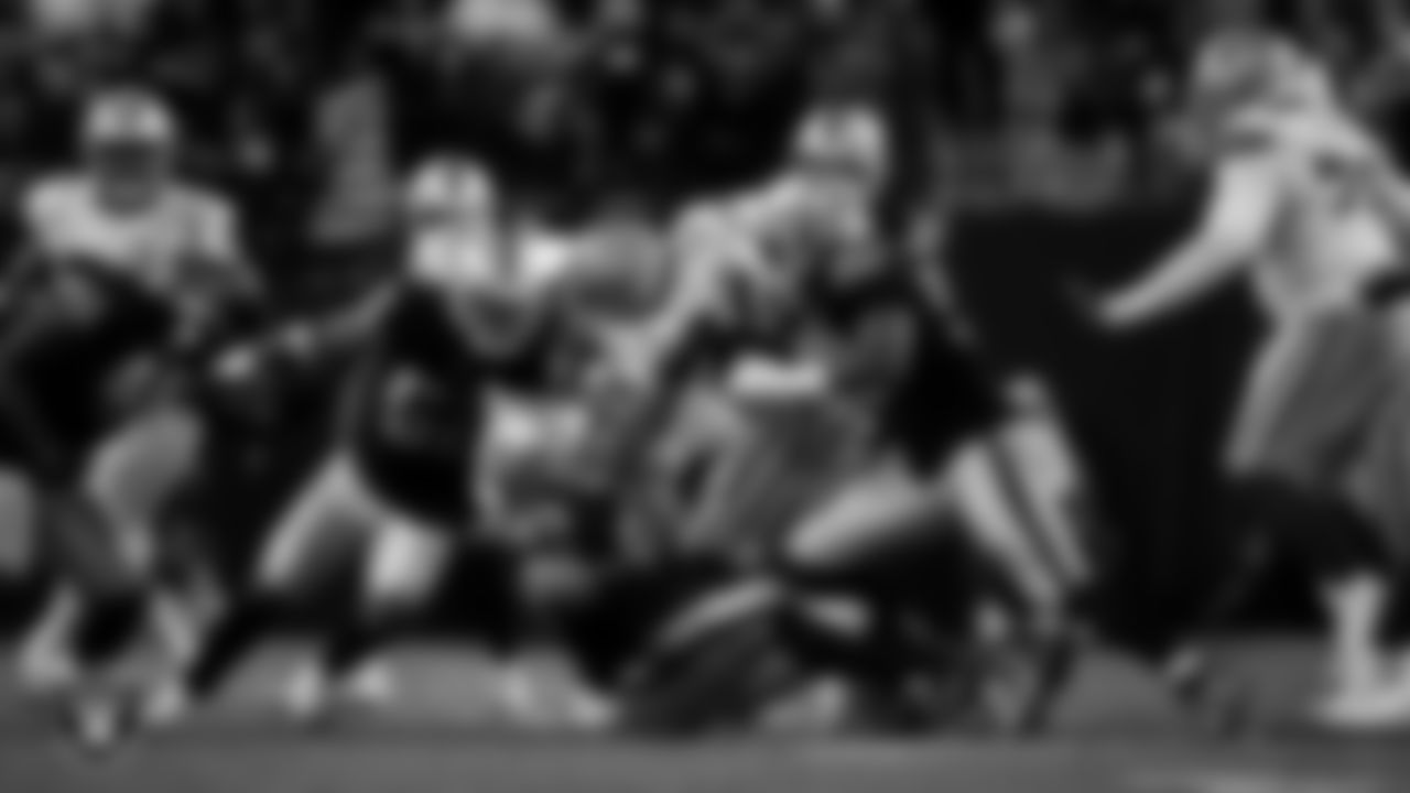 Las Vegas Raiders defensive tackle Thomas Booker IV (99) and defensive tackle Jonah Laulu (96) make a tackle during the regular season home game against the Dallas Cowboys at Allegiant Stadium.