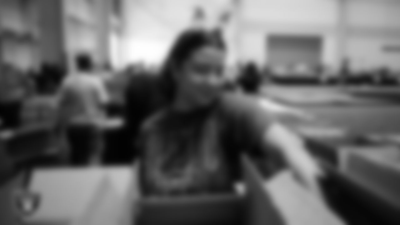 Las Vegas Raiders staff members help pack meals during the Raiders Holiday Meal Packing Party at Intermountain Health Performance Center.