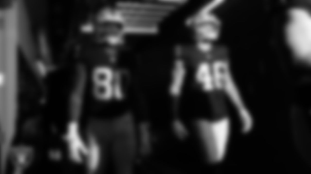Las Vegas Raiders tight end Ian Thomas (80) and tight end Carter Runyon (46) walk down the tunnel before the regular season home game against the Tennessee Titans at Allegiant Stadium.