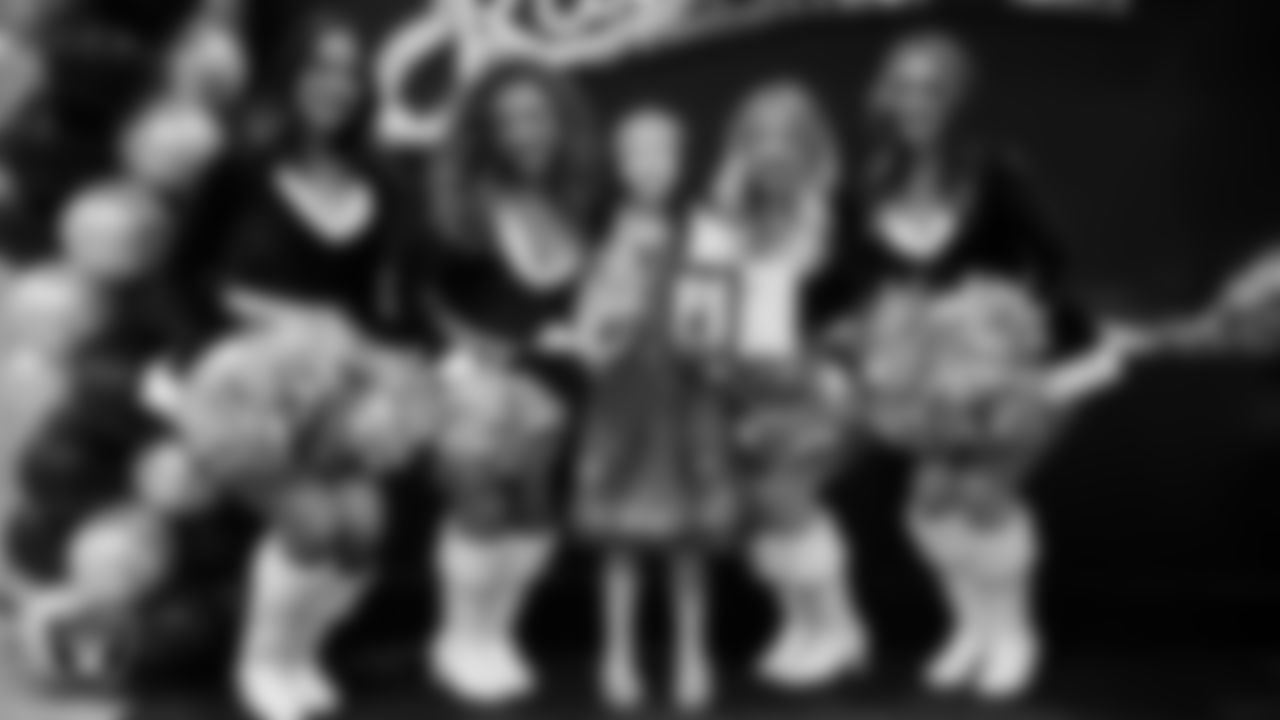 Raiderettes pose for a photo with a Junior Raiderette during the Junior Raiderettes Banquet at The Studio.