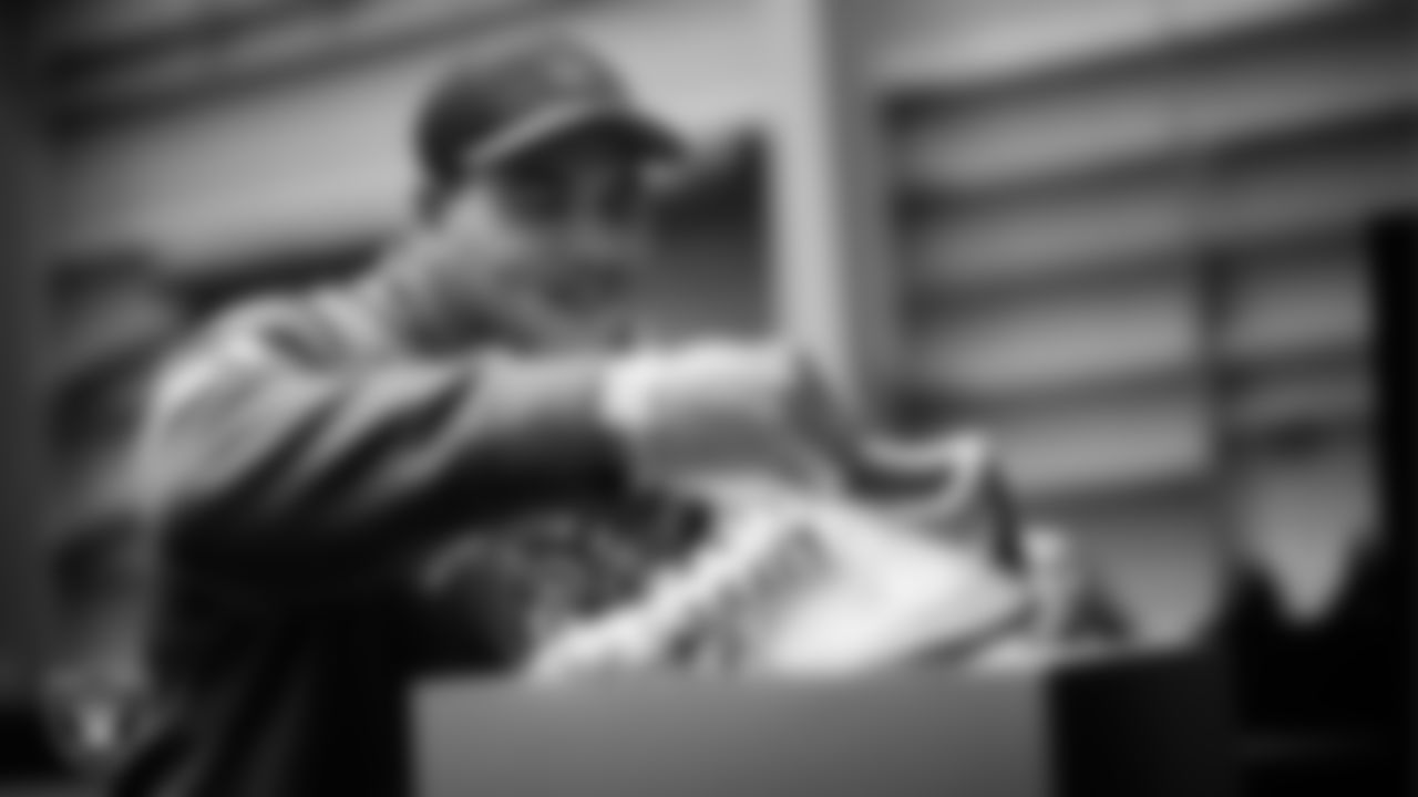 Las Vegas Raiders linebacker Brennan Jackson (54) unboxes his custom cleats for the NFL's My Cause My Cleats initiative at Intermountain Health Performance Center.