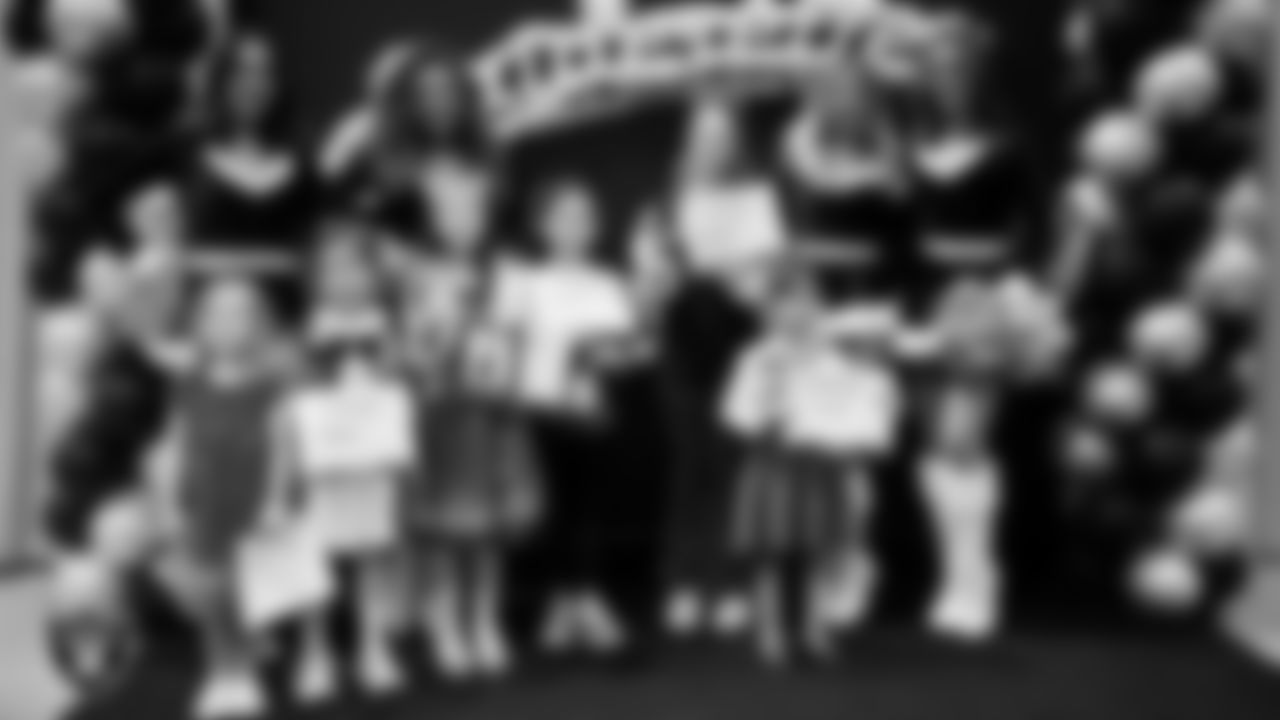 Raiderettes pose for a photo with Junior Raiderettes during the Junior Raiderettes Banquet at The Studio.