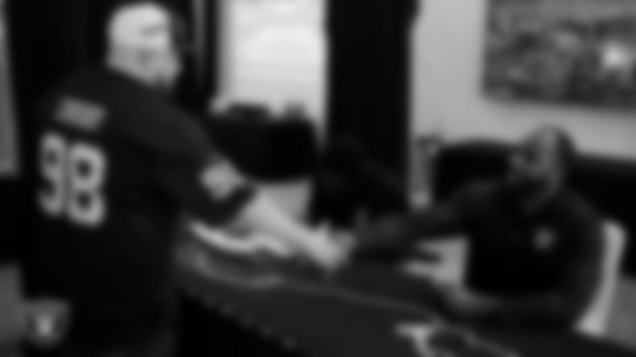 Las Vegas Raiders alumnus Darren McFadden signs an autograph for a service member at Nellis Air Force Base.