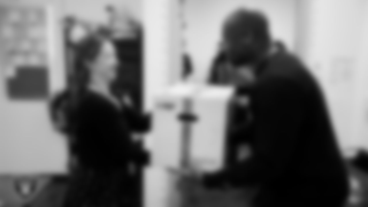 Las Vegas Raiders senior director of football development Myles Hayes presents a teacher with a classroom gift box during a Raiders Spirit Day at Richard H. Bryan Elementary School.