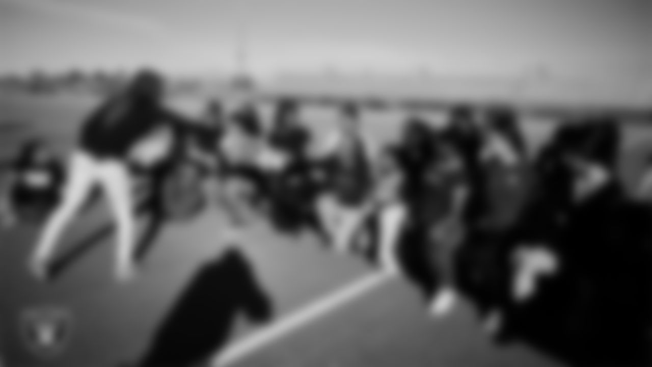 Las Vegas Raiders manager of football development Marli Bartlett shows off the championship belt to the Del Sol Academy of the Performing Arts flag football team during practice at Del Sol Academy of the Performing Arts.