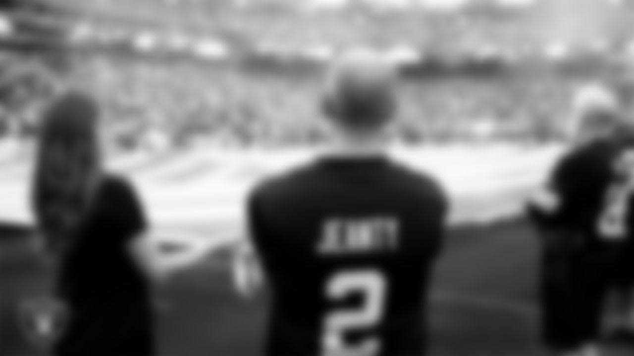 The American flag is displayed by Personal Seat License (PSL) holders on the field during the national anthem before the Las Vegas Raiders' preseason home game against the San Francisco 49ers at Allegiant Stadium.