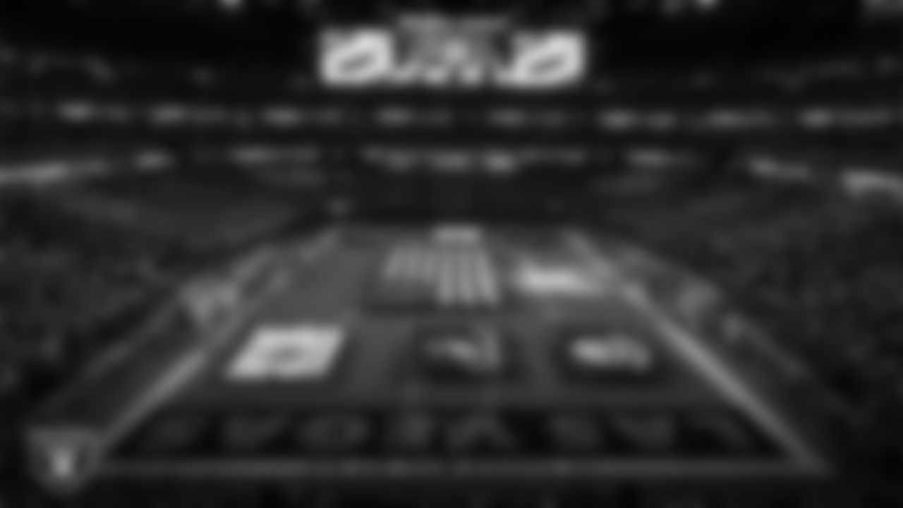 The American flag and military branch flags are displayed by Personal Seat License (PSL) holders on the field during the national anthem before the Las Vegas Raiders' regular season home game against the Dallas Cowboys at Allegiant Stadium.