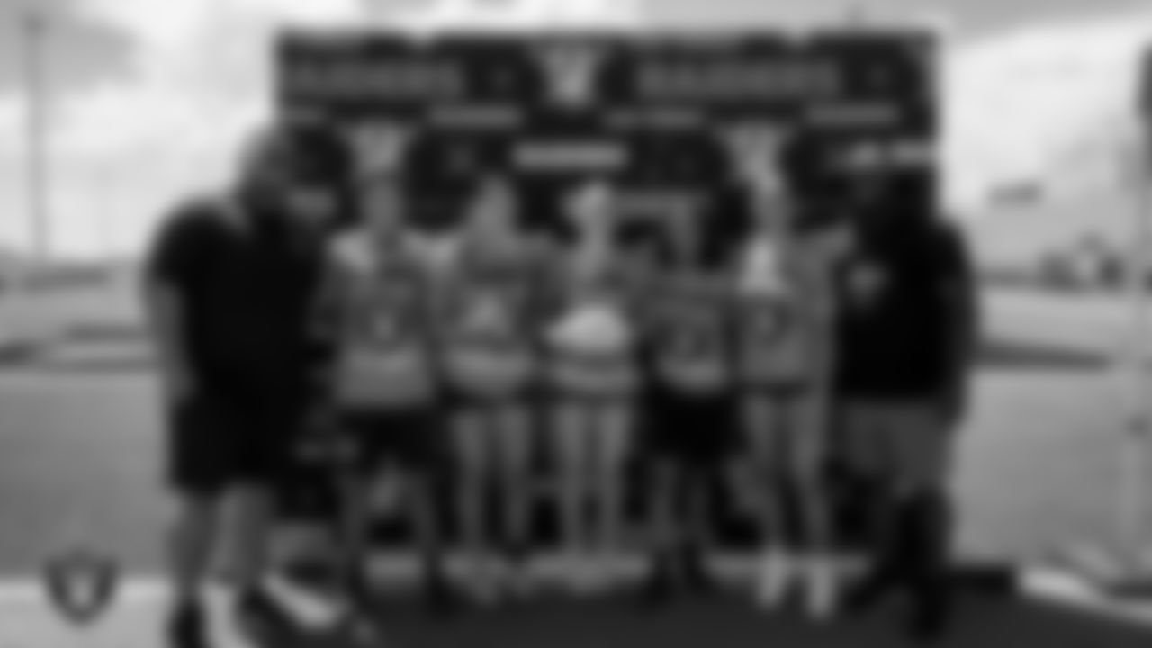 Athletes and their coaches pose for a photo during the girls division Silver and Black League playoff games at Western High School.