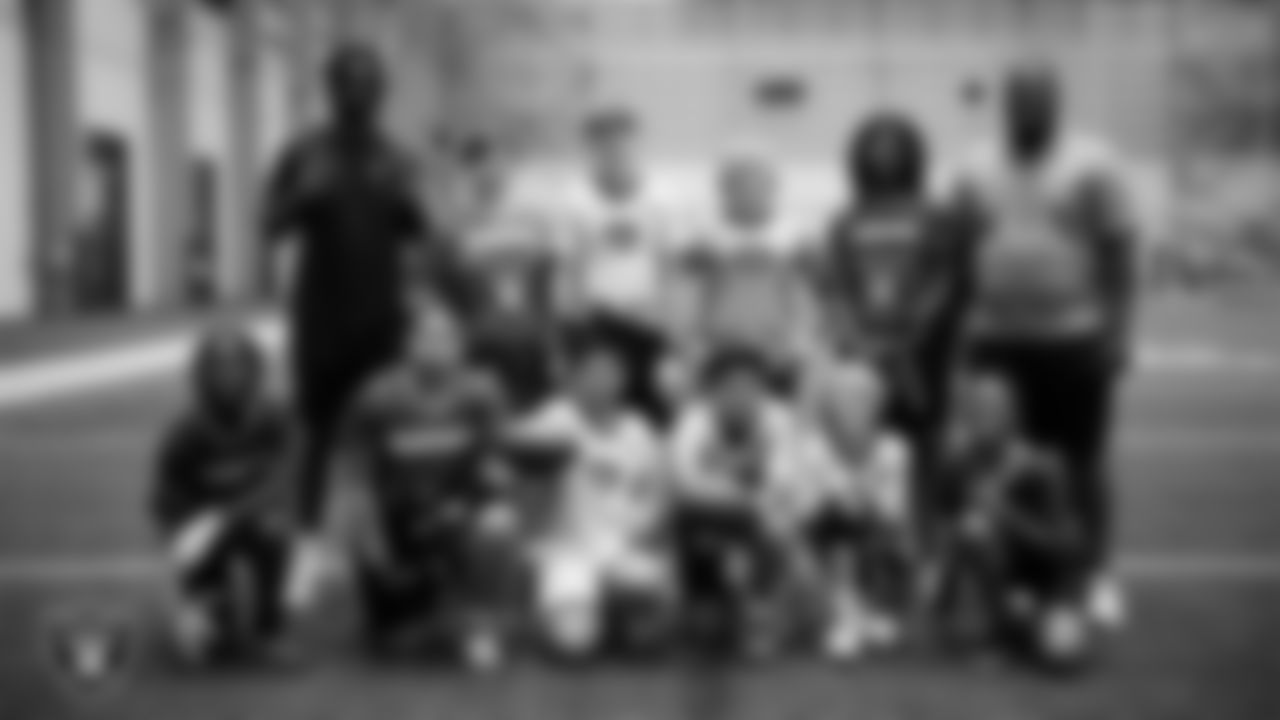 Athletes and coaches pose for a photo during practice at Intermountain Health Performance Center.