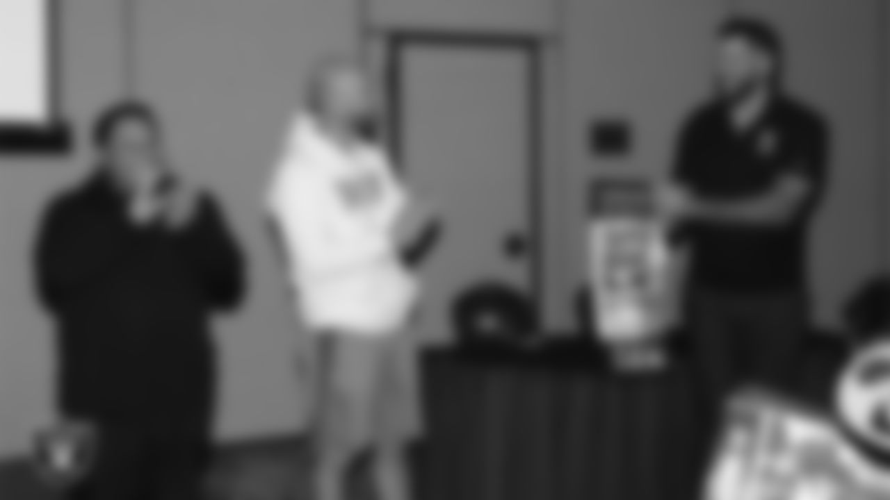 Las Vegas Raiders senior manager of football development Jordan Aguilar and alumnus Robert Gallery surprise Spanish Springs High School football coach and Tom Flores High School Coach of the Year Rob Hummel with Super Bowl LX tickets during a Glazier Clinic at Grand Sierra Resort.