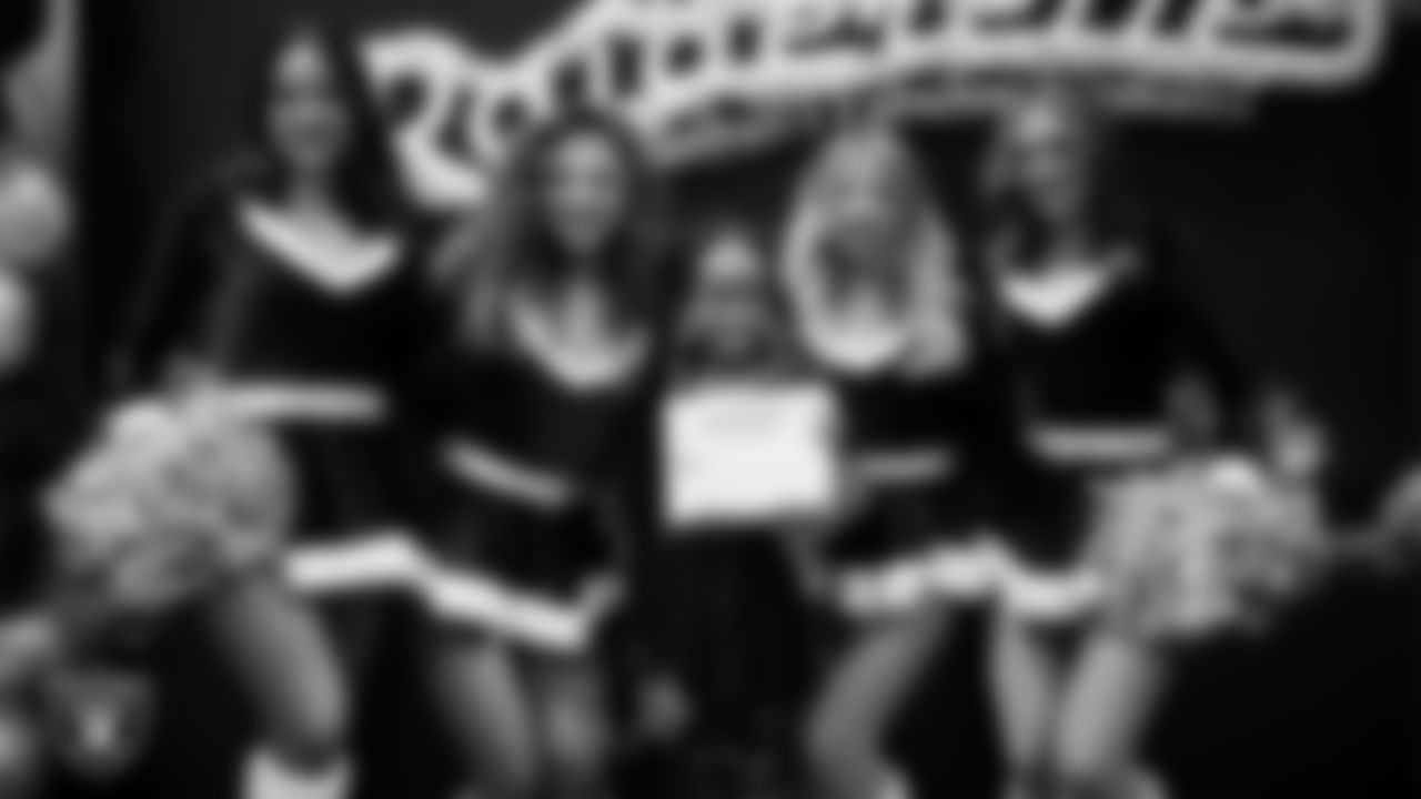 Raiderettes pose for a photo with a Junior Raiderette during the Junior Raiderettes Banquet at The Studio.