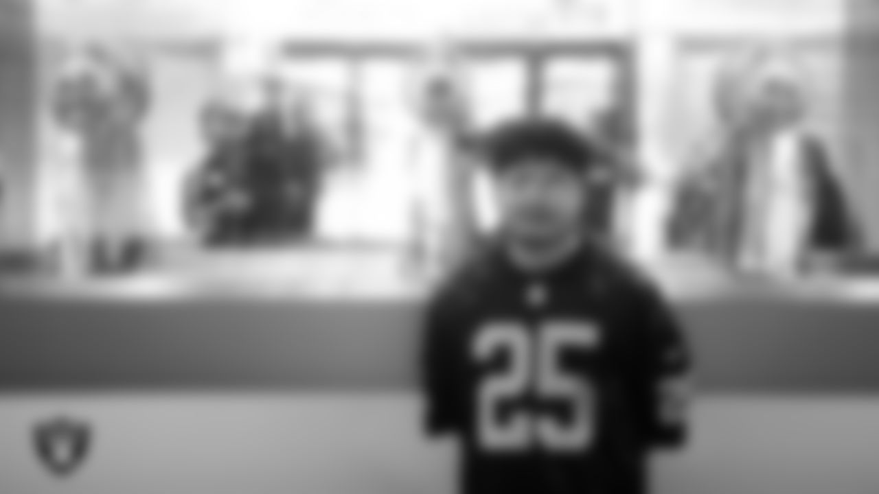 Marcos Carrillo from Make-A-Wish poses for a photo with the Las Vegas Raiders' Super Bowl trophies during a visit to Intermountain Health Performance Center.