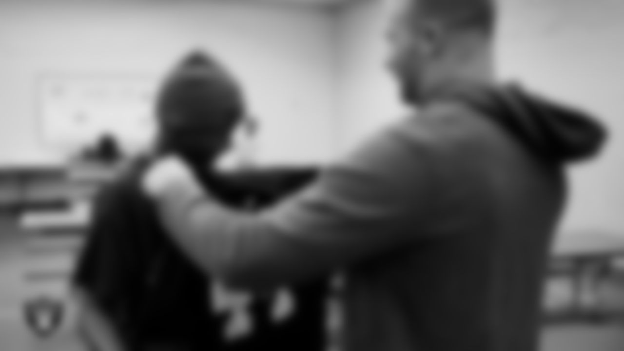 Las Vegas Raiders linebacker Tommy Eichenberg (44) gives his jersey to a member of the Boys and Girls Club at the Lied Memorial Boys & Girls Clubs of Southern Nevada.