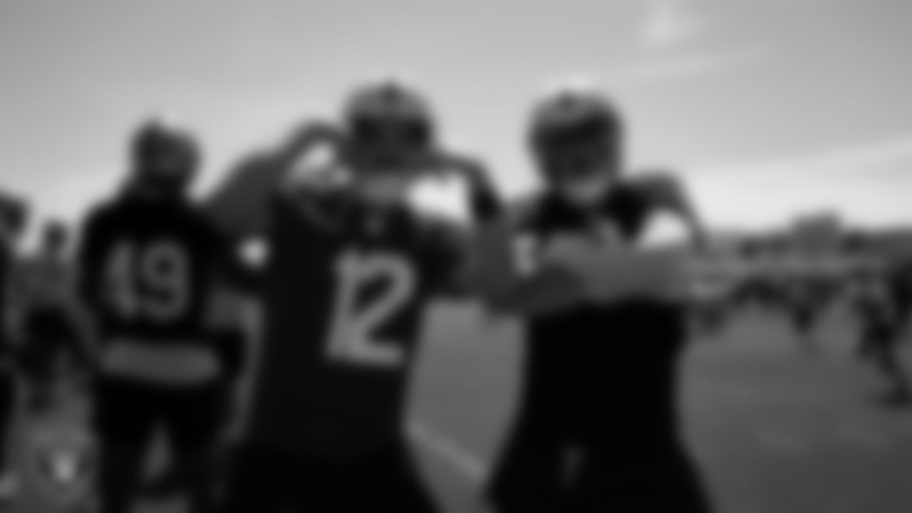 Las Vegas Raiders quarterback Aidan O'Connell (12) and defensive end Maxx Crosby (98) at an Organized Team Activity (OTA) at Intermountain Health Performance Center.
