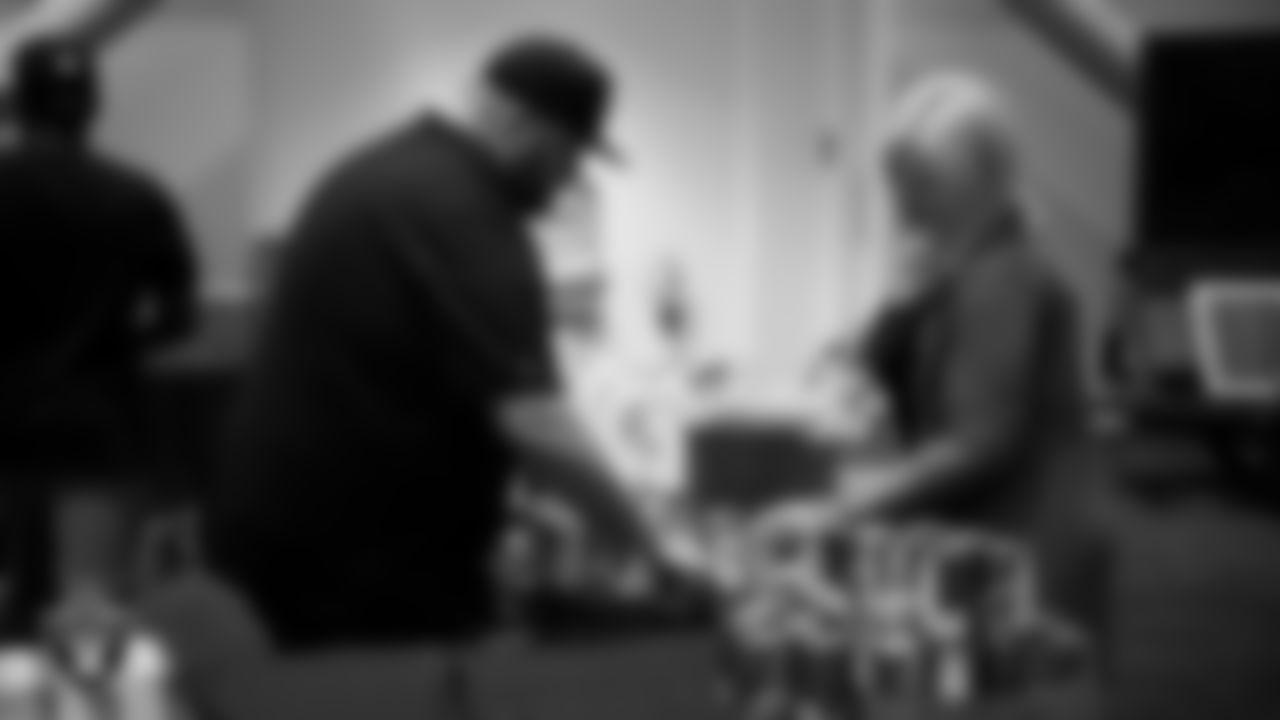 Las Vegas Raiders staff members help pack meals during the Raiders Holiday Meal Packing Party at Intermountain Health Performance Center.