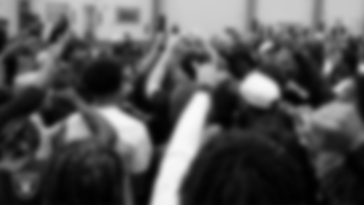 The Las Vegas Raiders huddle with the Owyhee High School football team during a walkthrough at Intermountain Health Performance Center.