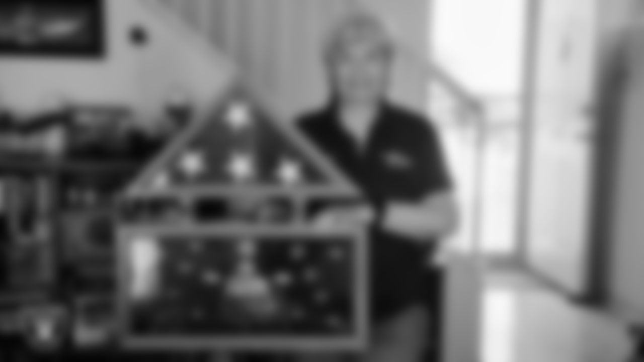 United States Air Force Veteran Bobi Oates poses for a photo with her veteran shadowbox after being surprised with tickets to the Las Vegas Raiders' Salute to Service game.