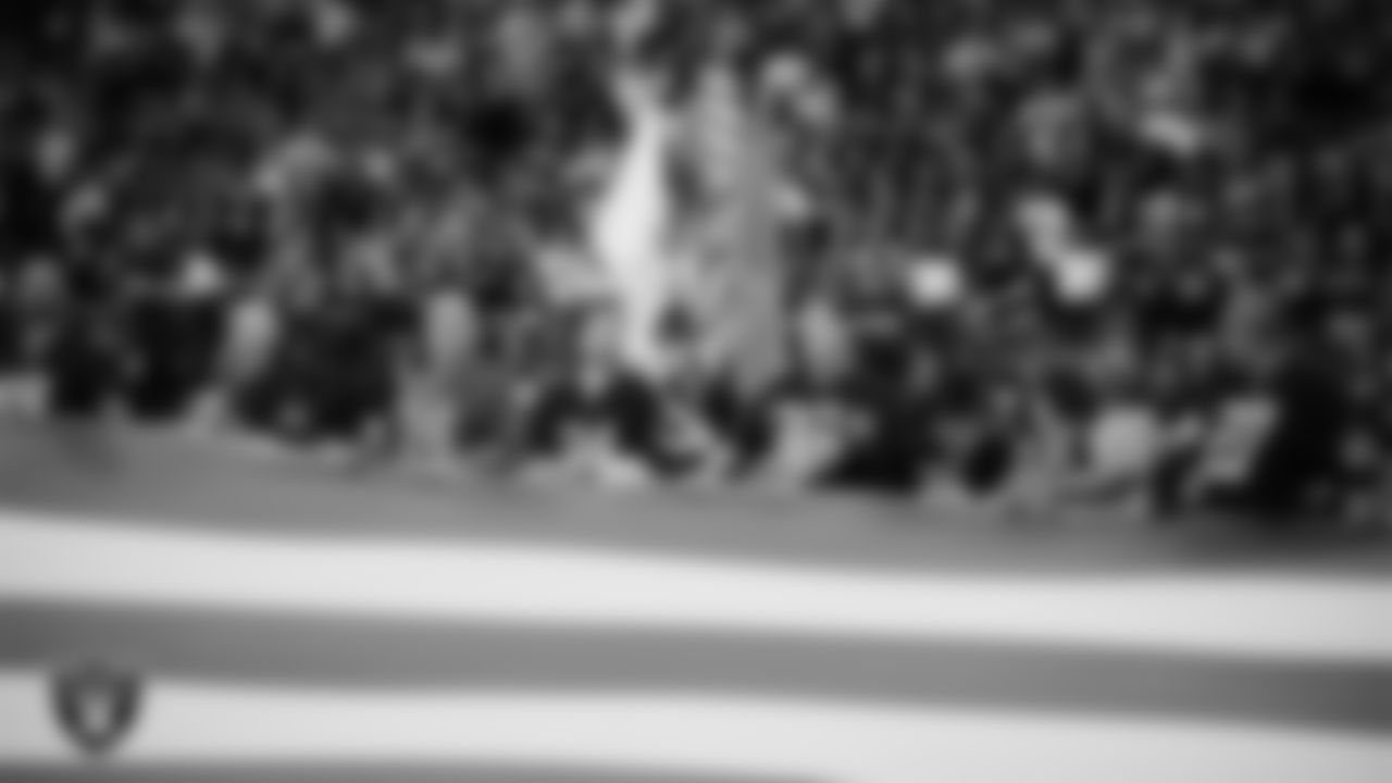 The American flag is displayed by Personal Seat License (PSL) holders on the field during the national anthem before the Las Vegas Raiders' regular season home game against the Jacksonville Jaguars at Allegiant Stadium.