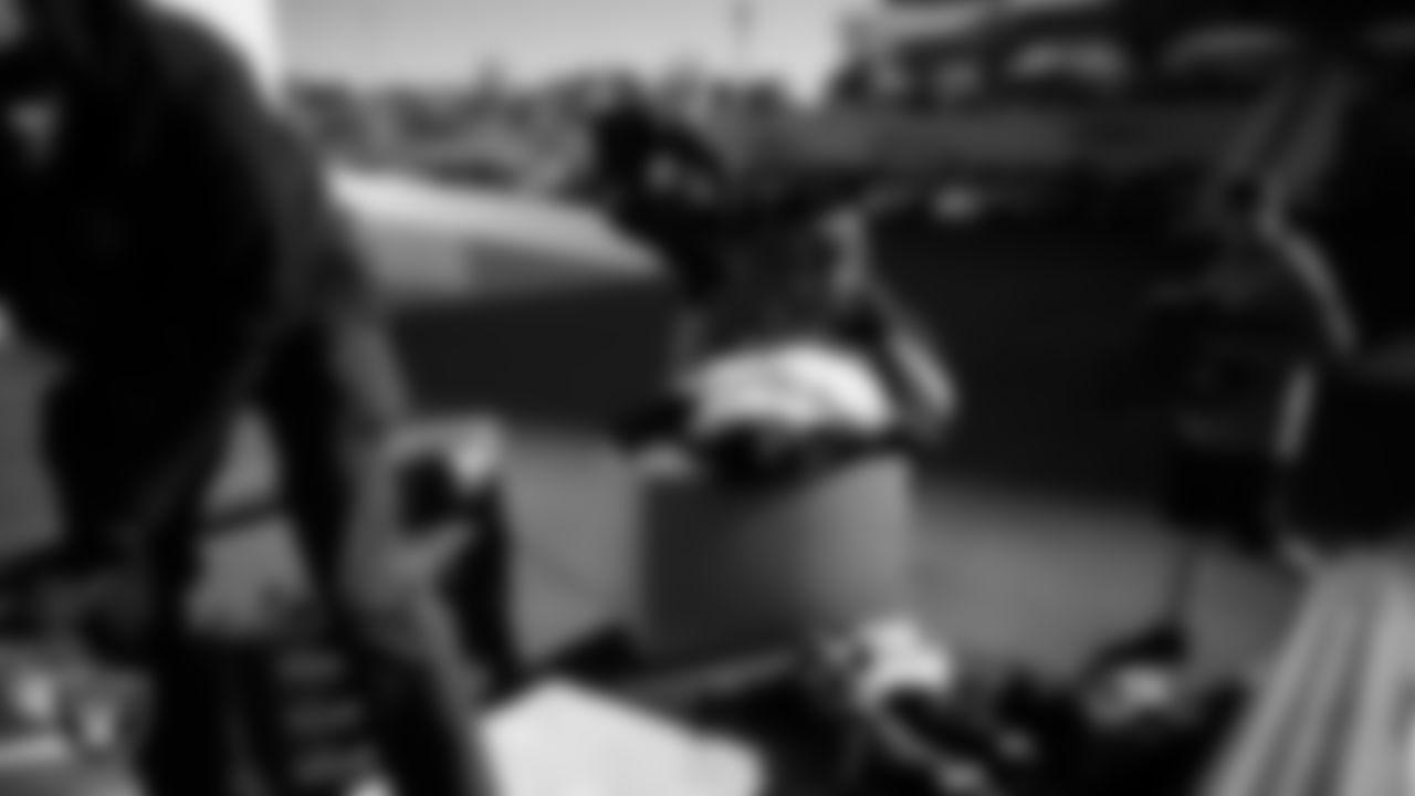 A Las Vegas Raiders ambassador loads equipment into a vehicle during the Raiders' Equipment Blitz at Intermountain Health Performance Center.