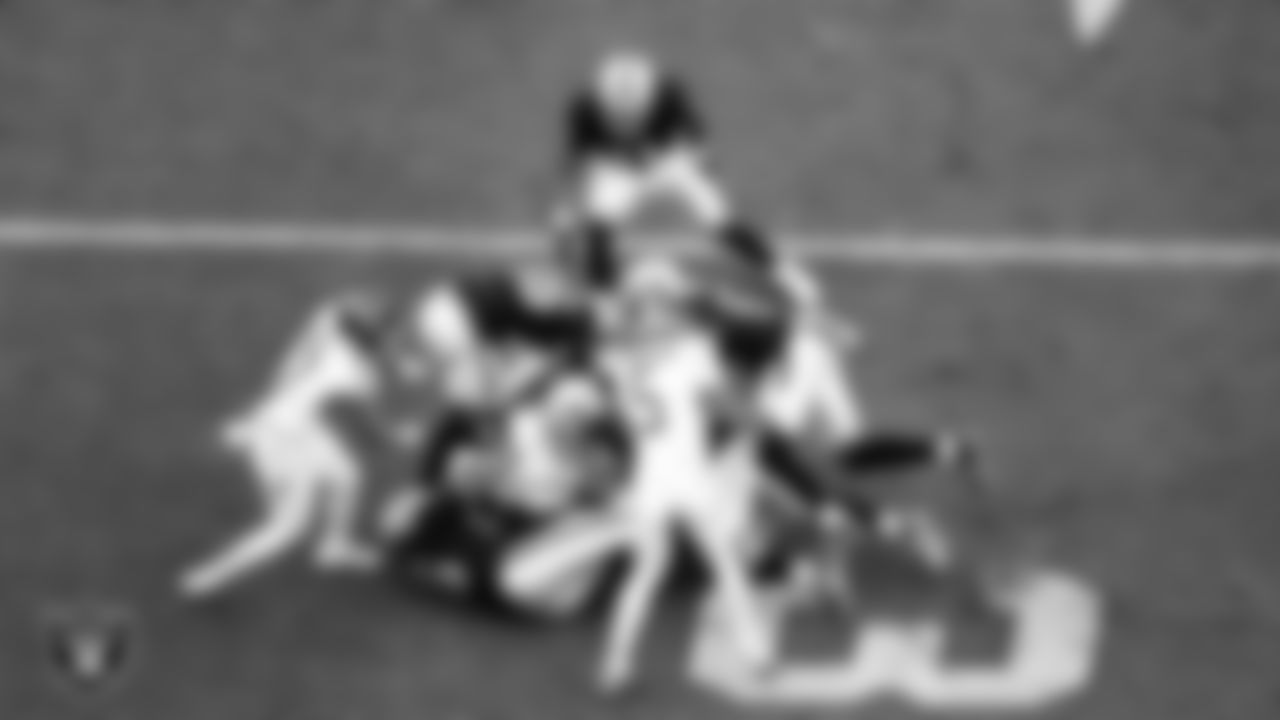 Las Vegas Raiders defensive tackle Jonah Laulu (96), cornerback Kyu Blu Kelly (36), linebacker Elandon Roberts (52) and defensive end Malcolm Koonce (51) during the regular season home game against the Tennessee Titans at Allegiant Stadium.