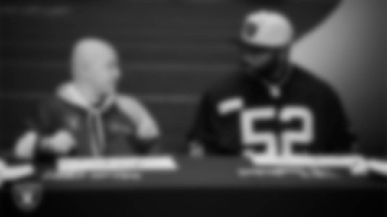 Las Vegas Raiders linebacker Elandon Roberts (52) designs cleats for My Cause My Cleats with Intermountain Children's Health patient Isaak at Intermountain Health Performance Center.