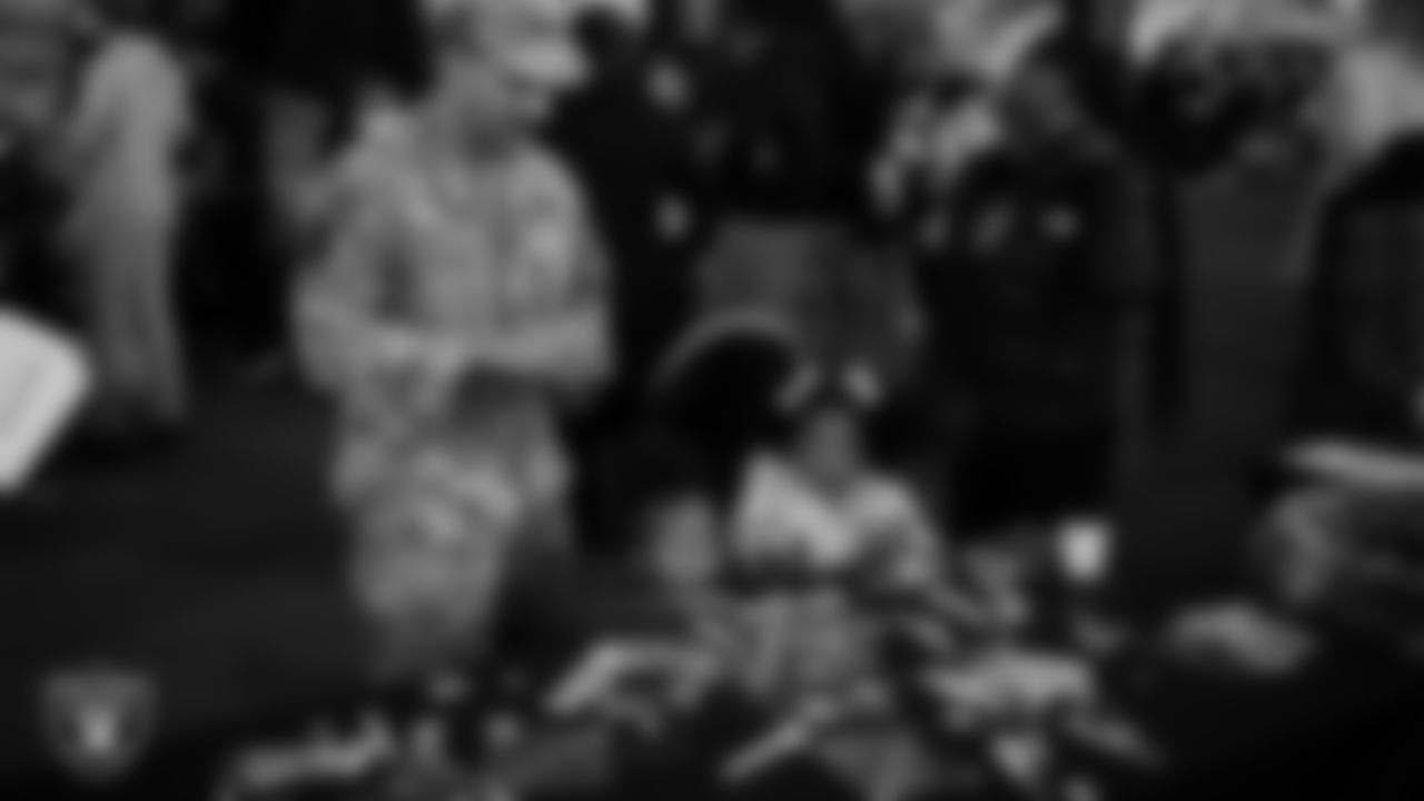 Children decorate ornaments during the Raiders Holiday Salute at Nellis Air Force Base - Coral Academy.