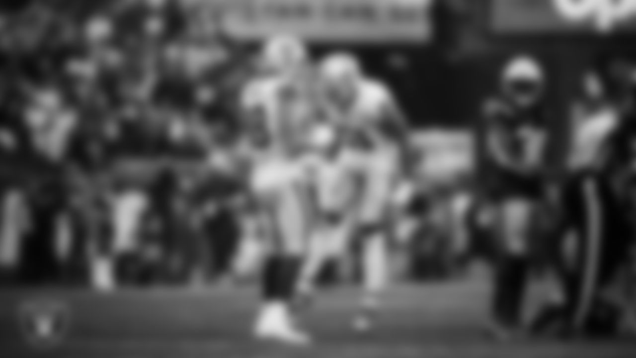 Las Vegas Raiders defensive end Malcolm Koonce (51) celebrates with defensive end Maxx Crosby (98) after sacking the quarterback and forcing a fumble during the regular season away game against the New England Patriots at Gillette Stadium.