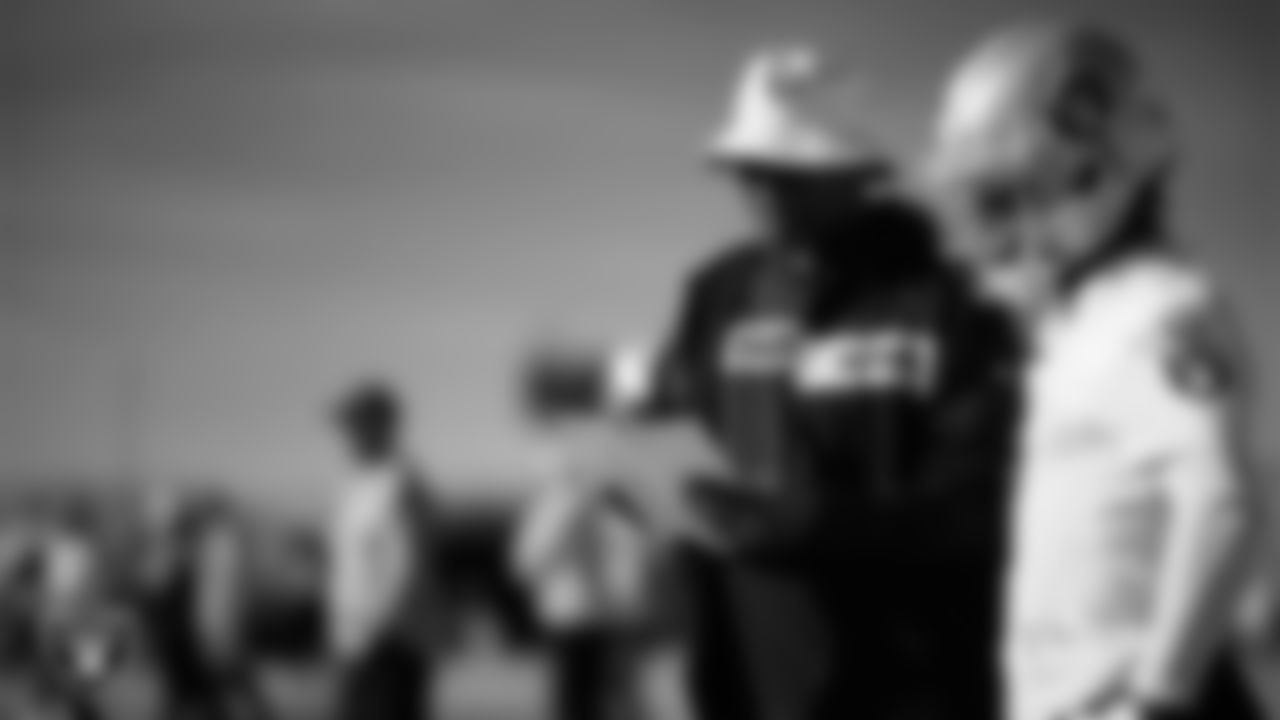 Las Vegas Raiders wide receivers coach Edgar Bennett and wide receiver Tre Tucker (11) during practice at Intermountain Health Performance Center.