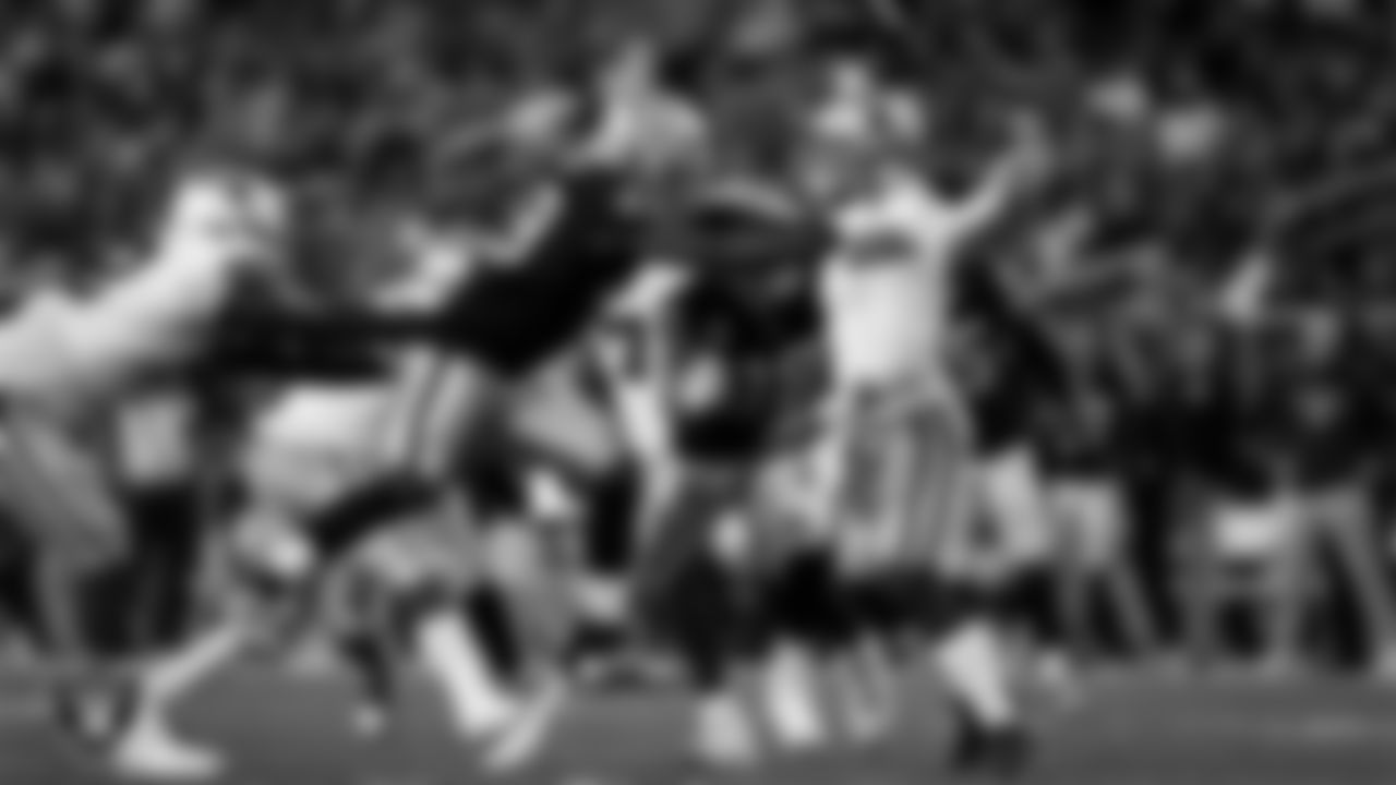 Las Vegas Raiders linebacker Jamin Davis (48) and defensive end Maxx Crosby (98) pressure the quarterback during the regular season home game against the Dallas Cowboys at Allegiant Stadium.