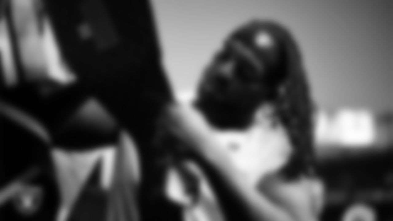 Las Vegas Raiders defensive tackle Adam Butler (69) signs autographs for fans before the regular season away game against the Denver Broncos at Empower Field at Mile High.