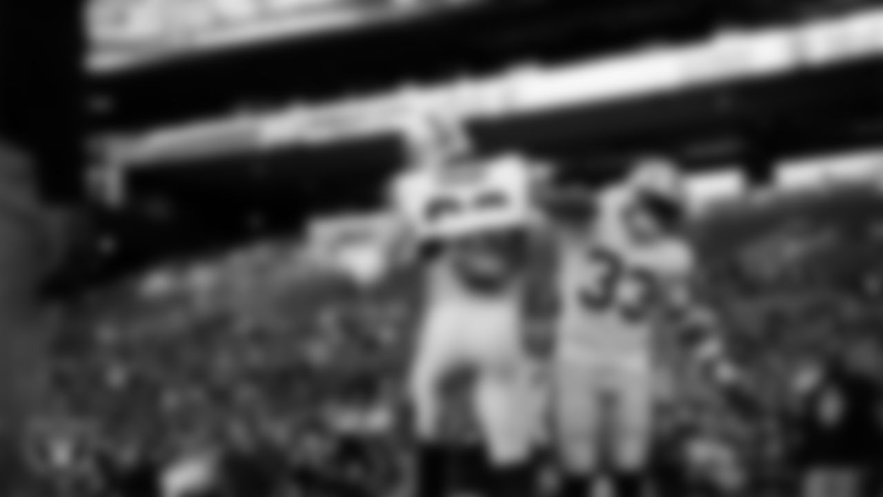 Las Vegas Raiders defensive end Maxx Crosby (98) and safety Jamal Adams (33) warming up before the preseason away game against the Seattle Seahawks at Lumen Field.