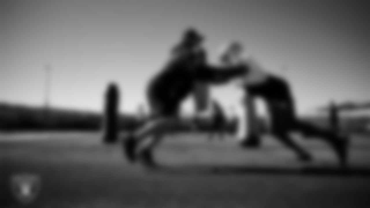 Las Vegas Raiders defensive assistant Rip Rowan and defensive end Tyree Wilson (9) during practice at Intermountain Health Performance Center.