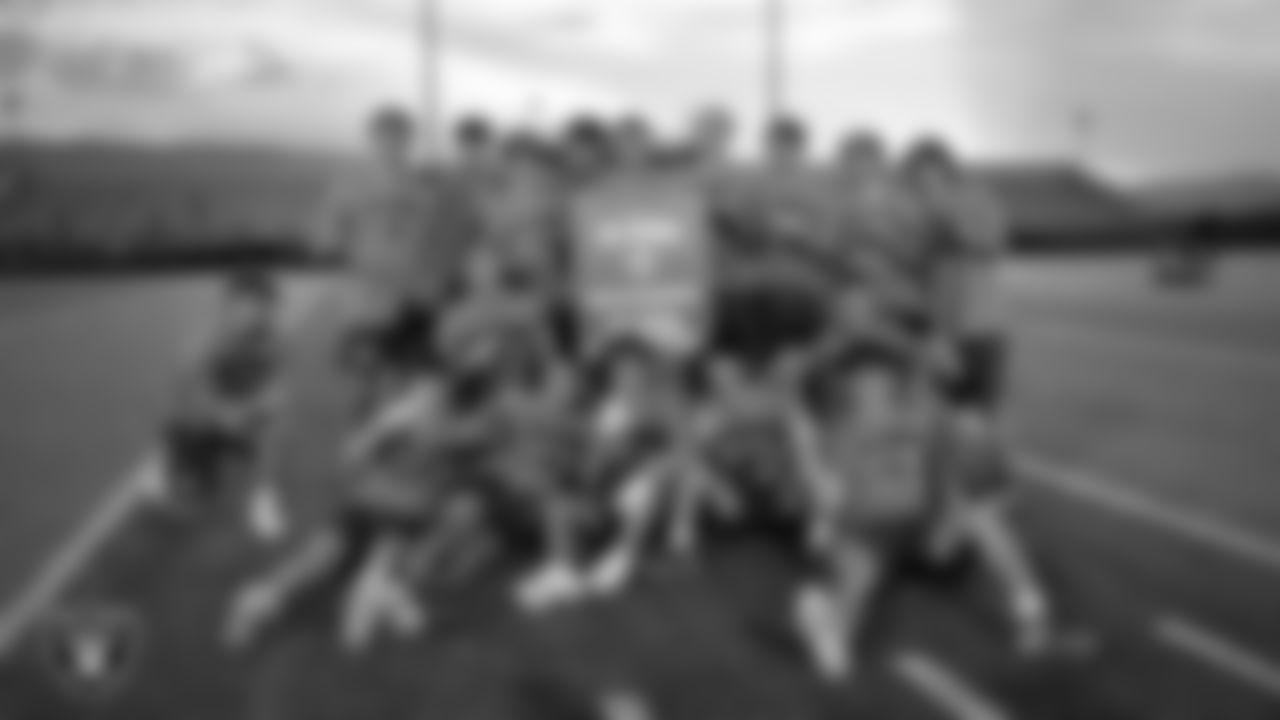 Reno High School football players pose for a photo after being named champions of the Las Vegas Raiders 11-ON event at Damonte Ranch High School.