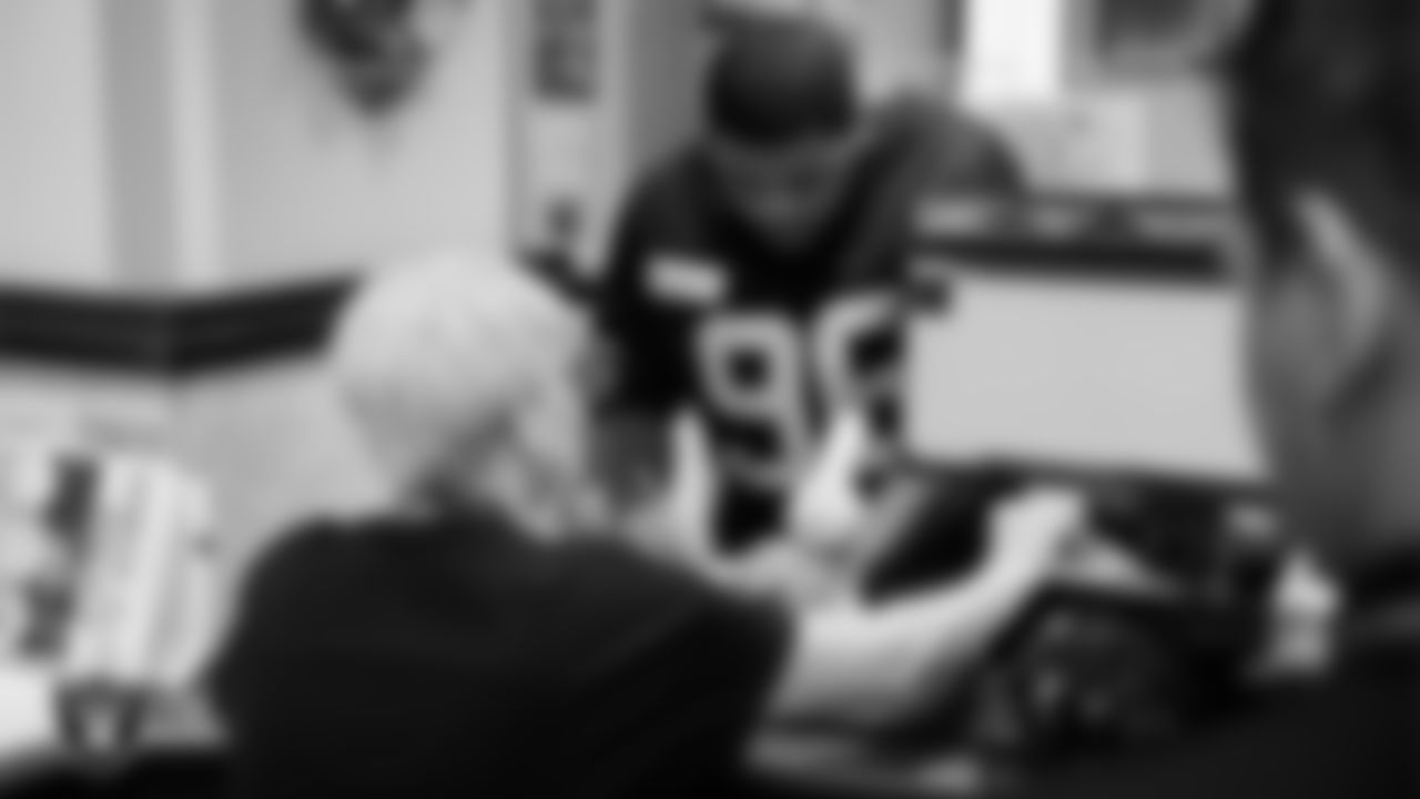 Las Vegas Raiders defensive tackle Jonah Laulu (96) signs up for a Raiders edition library card during a launch event at Aliante Library.