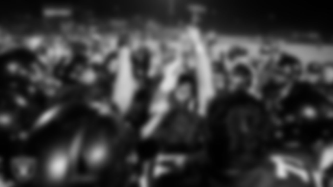 The Virgin Valley High School football team celebrates with the "Hammer Game" trophy after the Las Vegas Raiders' Football Showcase game at Moapa Valley High School.