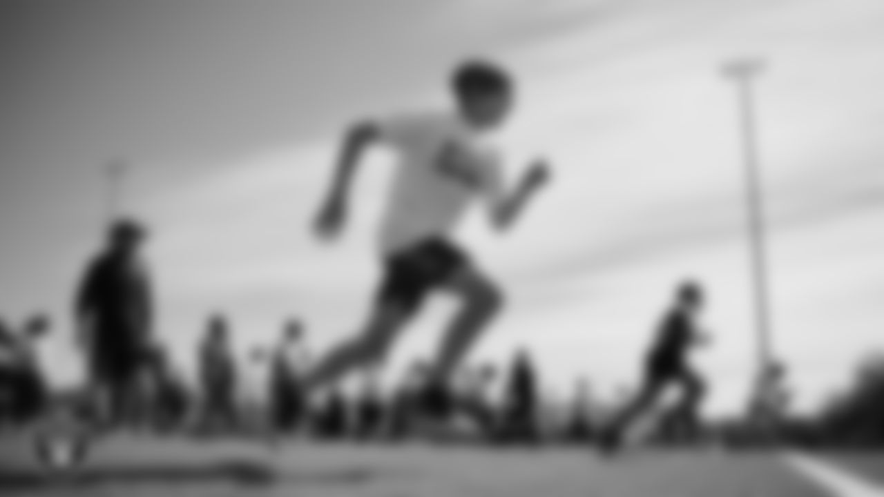 An athlete goes through a drill during a youth football combine at Durango High School.