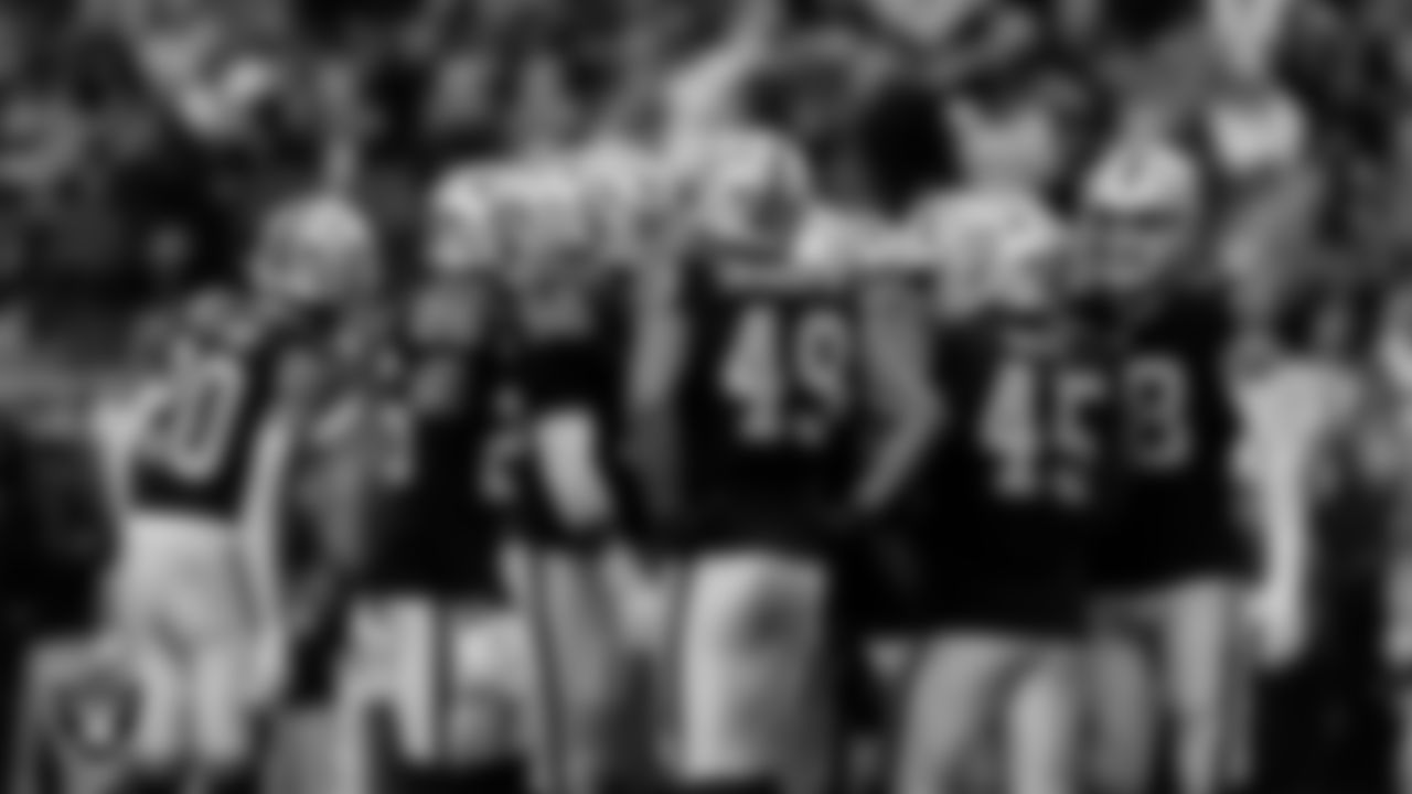 The Las Vegas Raiders huddle during the regular season home game against the Denver Broncos at Allegiant Stadium.