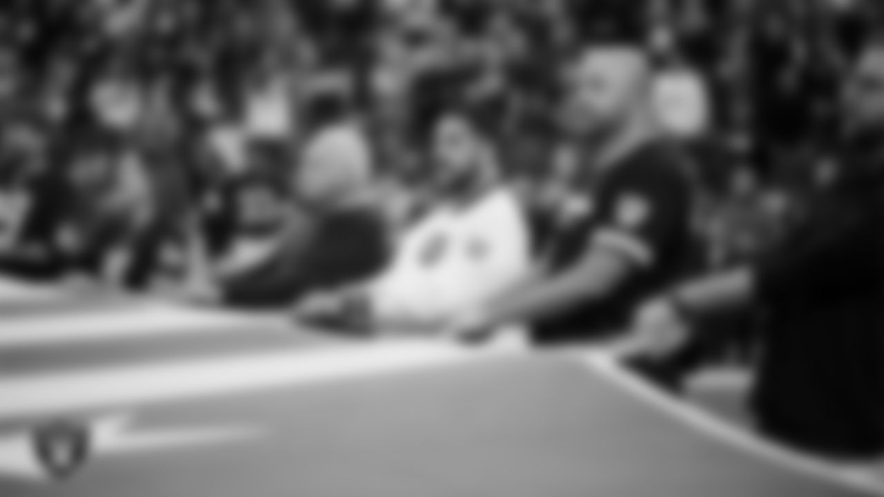 The American flag is displayed by Personal Seat License (PSL) holders on the field during the national anthem before the Las Vegas Raiders' regular season home game against the Cleveland Browns at Allegiant Stadium.