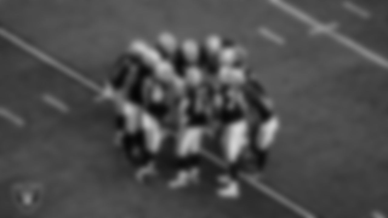 The Las Vegas Raiders huddle during the regular season home game against the Denver Broncos at Allegiant Stadium.