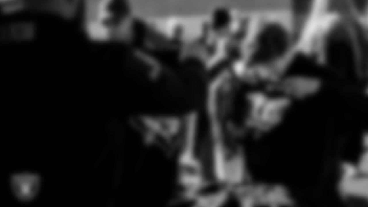 An attendee receives Las Vegas Raiders gear during Silver and Black Saturday at Liberty High School.