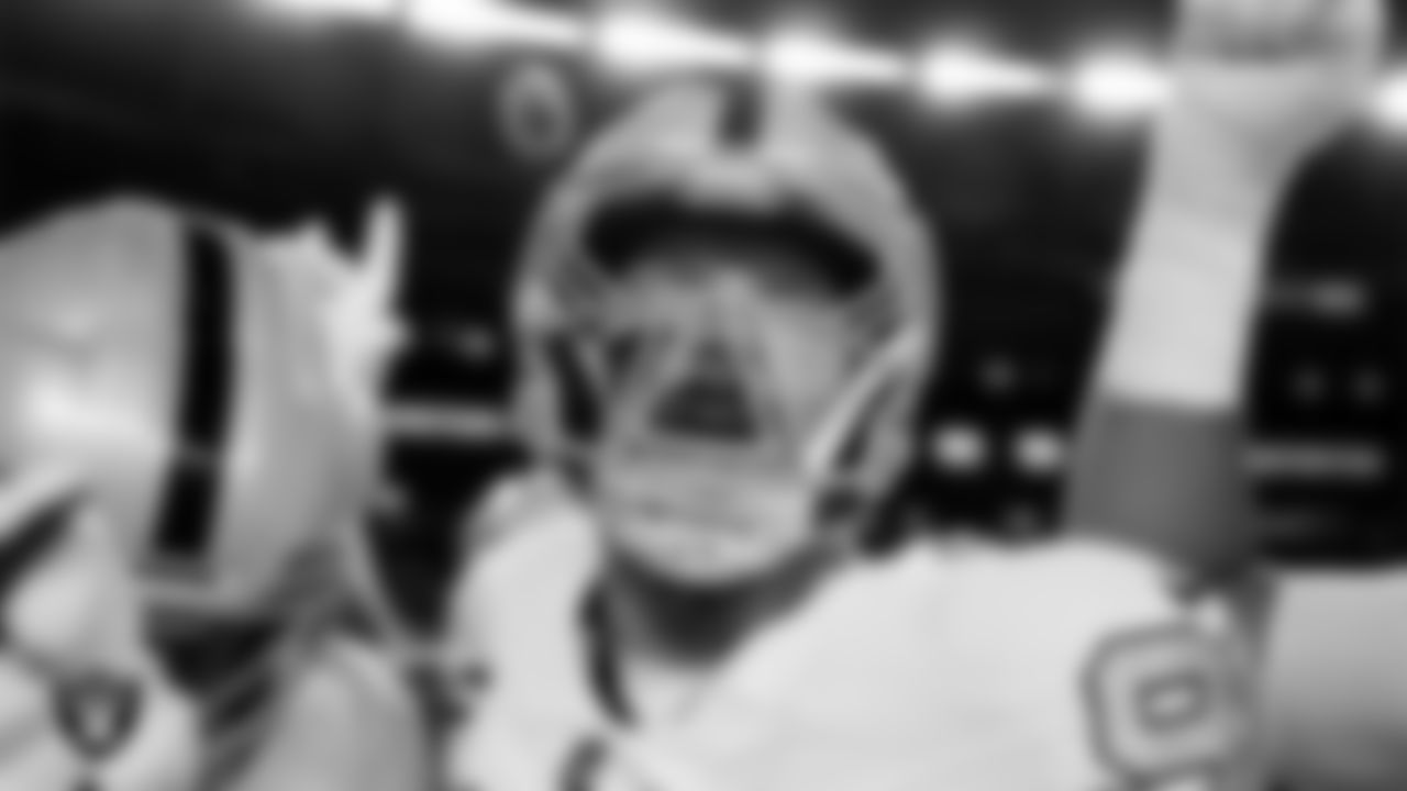 Las Vegas Raiders defensive end Maxx Crosby (98) in a huddle before the regular season away game against the Denver Broncos at Empower Field at Mile High.