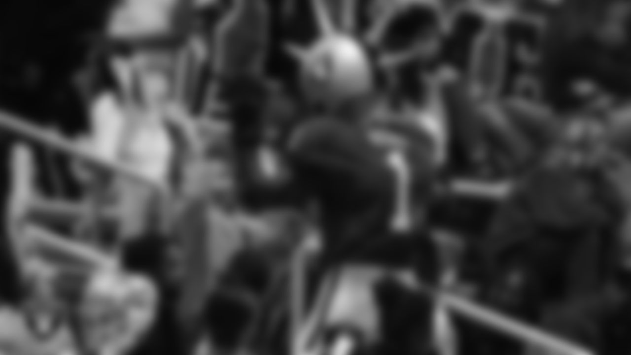 Raider Rusher high-fives a fan during the Las Vegas Raiders' High School Flag Football Showcase game at Mater East Academy.