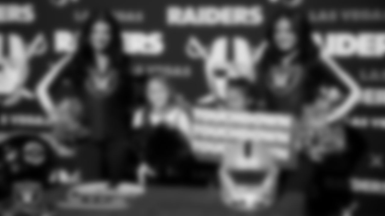 Raiderettes Kylee and Sloane pose for a photo with athletes during the LEEAP Flag Football Tournament at Desert Breeze Park.