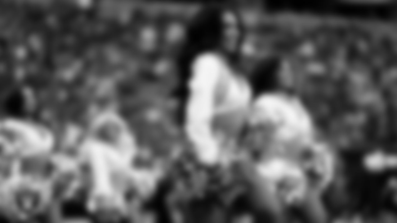 Raiderette Cierra walks onto the field for a performance during the preseason home game against the San Francisco 49ers at Allegiant Stadium.