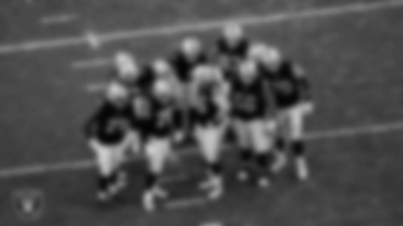 The Las Vegas Raiders huddle during the regular season home game against the Kansas City Chiefs at Allegiant Stadium.