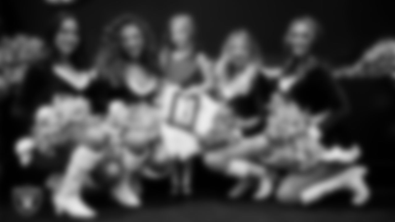 Raiderettes pose for a photo with a Junior Raiderette during the Junior Raiderettes Banquet at The Studio.