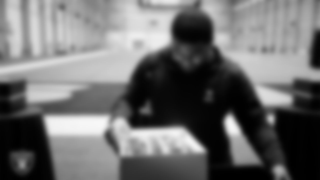 Las Vegas Raiders defensive tackle Jonah Laulu (96) unboxes his custom cleats for the NFL's My Cause My Cleats initiative at Intermountain Health Performance Center.