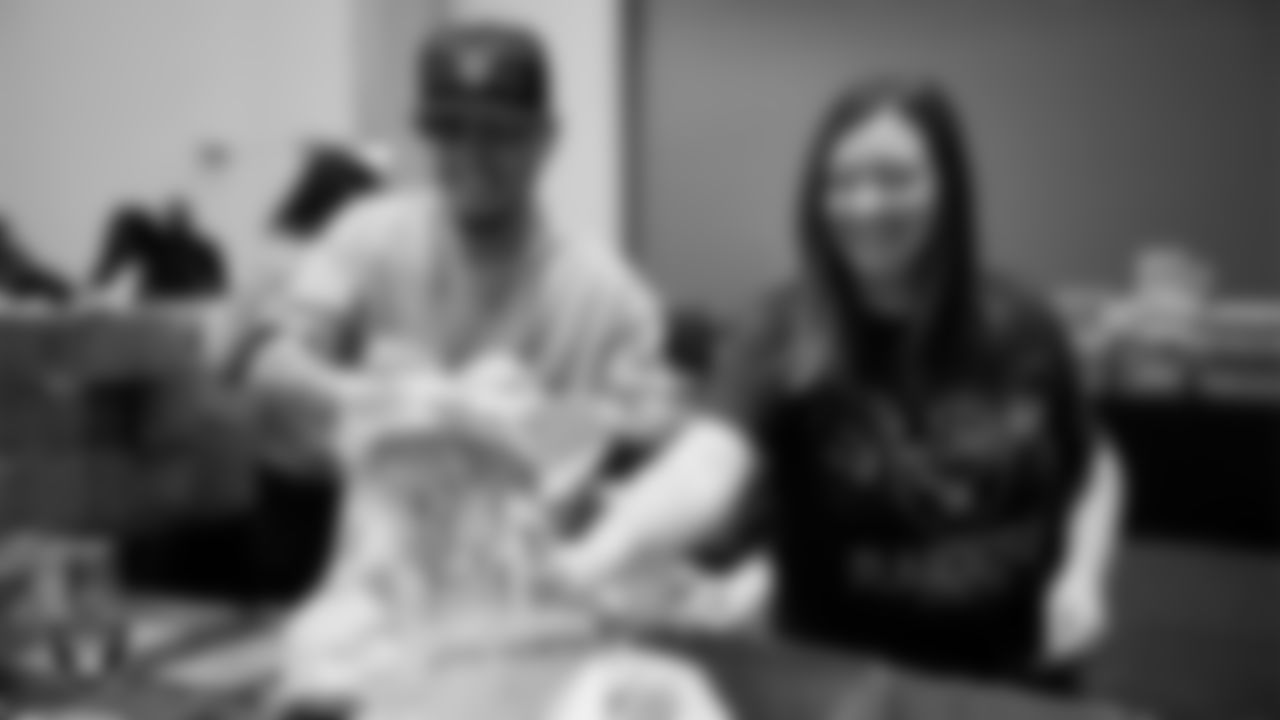 Las Vegas Raiders staff members help pack meals during the Raiders Holiday Meal Packing Party at Intermountain Health Performance Center.