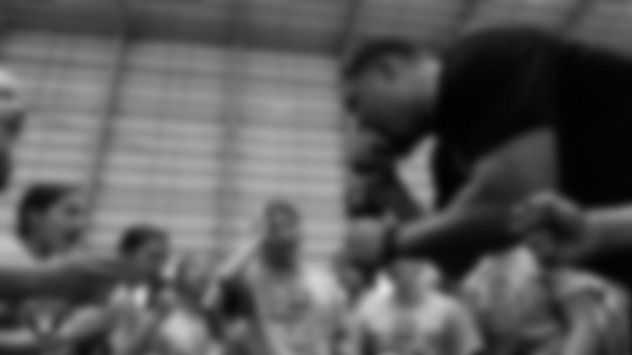 Las Vegas Raiders alumnus Teyo Johnson huddles with athletes after ELITE Academy at Intermountain Health Performance Center.