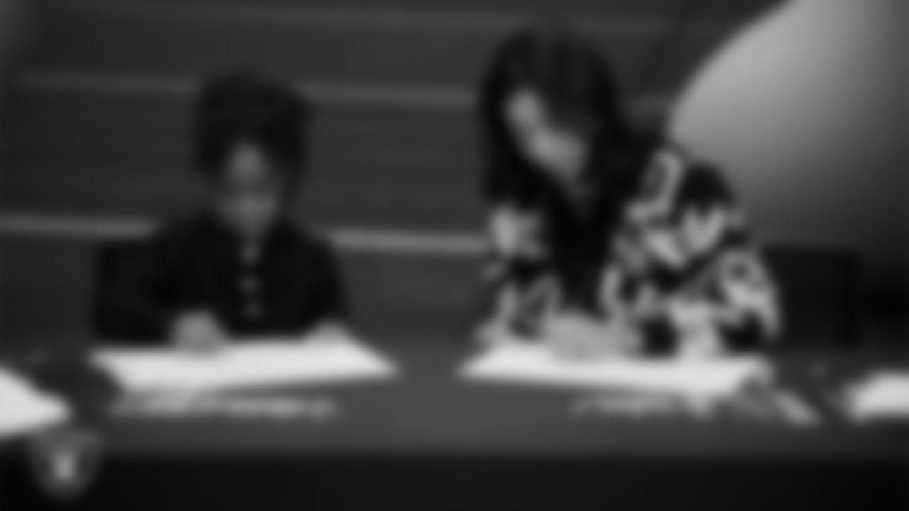 Las Vegas Raiders President Sandra Douglass Morgan designs custom shoes for My Cause My Cleats with Intermountain Children's Health patient Evelyn at Intermountain Health Performance Center.